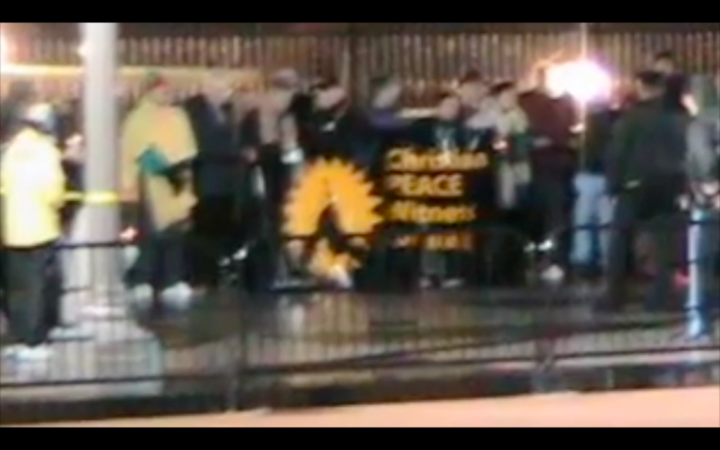 Screenshot from the video, showing demonstrators at night.