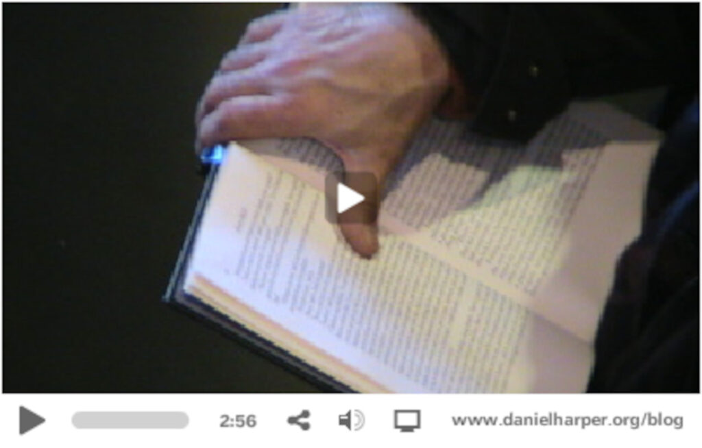Screen grab from the video showing someone holding a book.