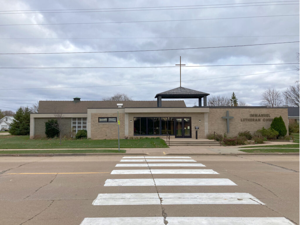 Suburban streetscape with modernist church building from the late twentieth century.