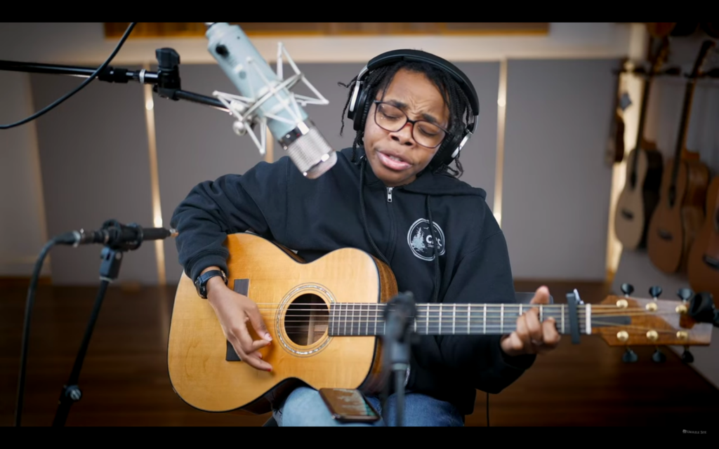 Screen grab from the video podcast mentioned in the post, showing Spirit Artis singing and playing guitar