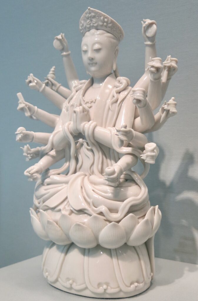 Porcelain statue of a goddess with eighteen arms.