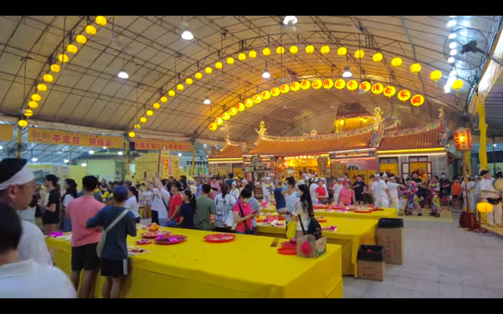 A large indoor area with crowds of people.